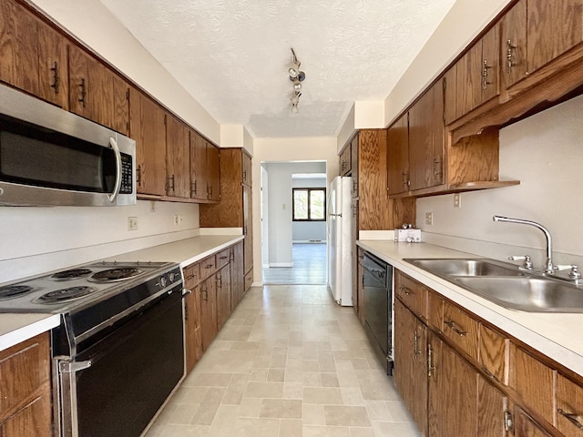 3101 Simpson Dr, Somerset, KY 42503 - kitchen featuring black appliances, light countertops, brown cabinets, a textured ceiling, and a sink