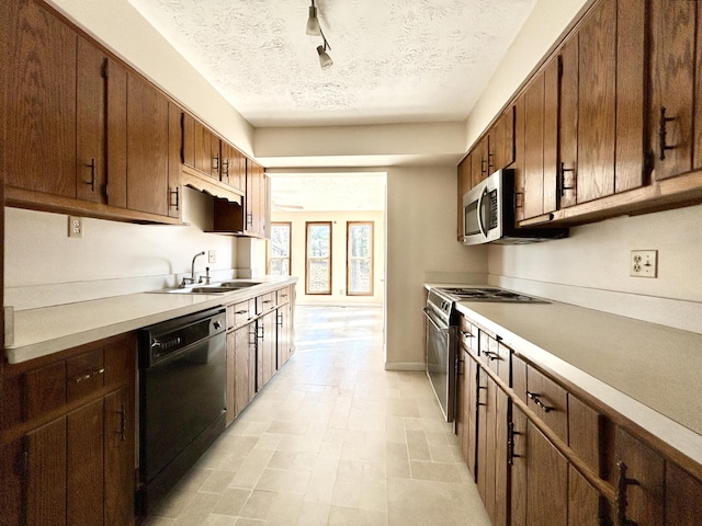 3101 Simpson Dr, Somerset, KY 42503 - kitchen with a sink, light countertops, rail lighting, appliances with stainless steel finishes, and a textured ceiling