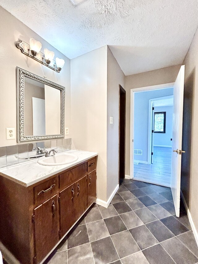 3101 Simpson Dr, Somerset, KY 42503 - bathroom featuring tile patterned floors, baseboards, a textured ceiling, and vanity