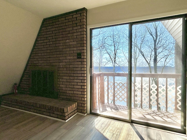3101 Simpson Dr, Somerset, KY 42503 - doorway to outside featuring a brick fireplace and wood finished floors