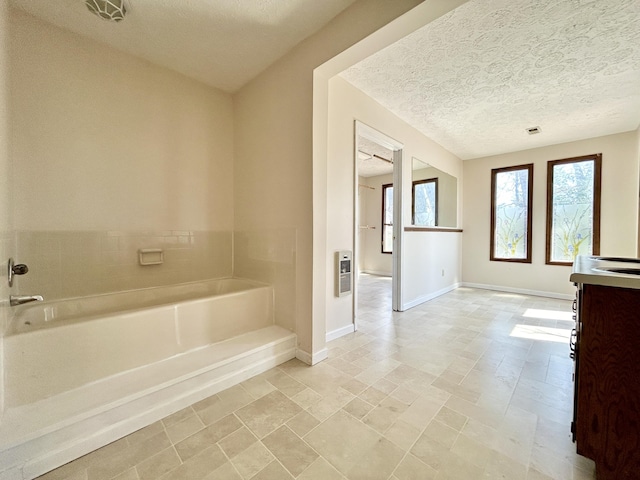 3101 Simpson Dr, Somerset, KY 42503 - full bath with vanity, heating unit, baseboards, a textured ceiling, and a bath