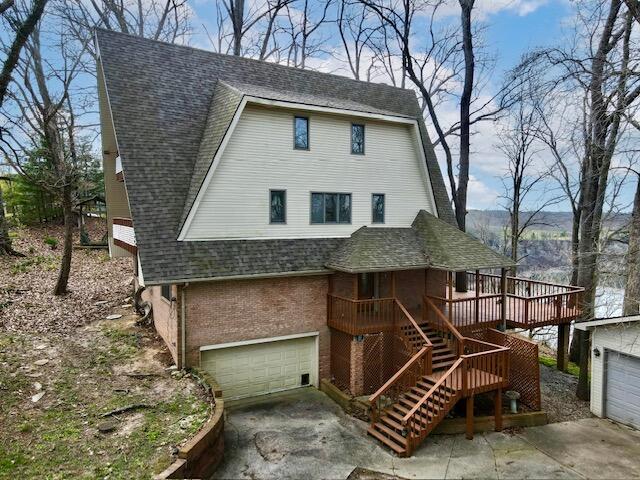 3101 Simpson Dr, Somerset, KY 42503 - view of front of house with brick siding, stairs, roof with shingles, a garage, and driveway