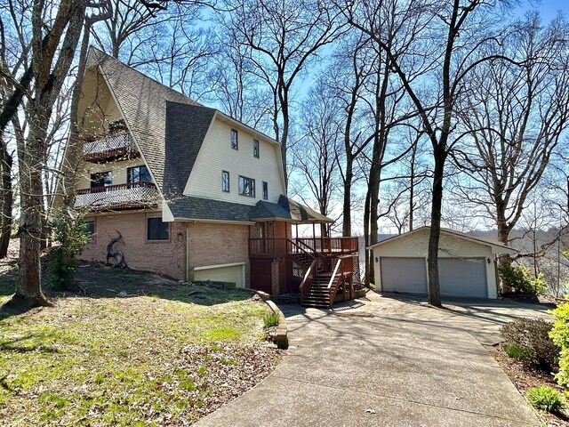 3101 Simpson Dr, Somerset, KY 42503 - view of property exterior featuring stairway, an outdoor structure, a shingled roof, a garage, and brick siding