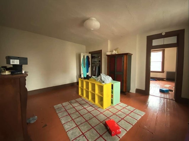 interior space with baseboards and wood finished floors