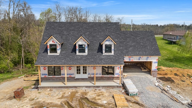 cape cod house with french doors, driveway, and roof with shingles