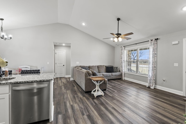 living room with ceiling fan with notable chandelier, lofted ceiling, dark wood-style floors, and baseboards