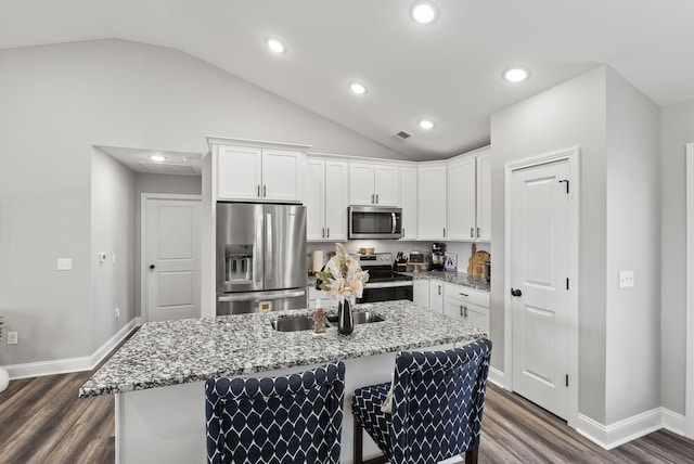 kitchen featuring dark wood-type flooring, white cabinets, light stone counters, and appliances with stainless steel finishes