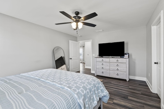 bedroom with dark wood finished floors, visible vents, a ceiling fan, and baseboards