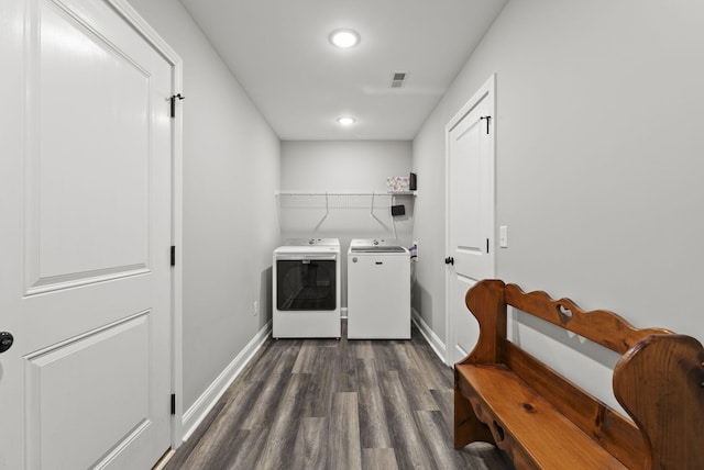 laundry area featuring baseboards, visible vents, washing machine and clothes dryer, laundry area, and dark wood-style flooring