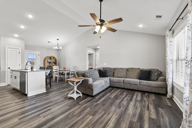 living room featuring visible vents, baseboards, lofted ceiling, ceiling fan with notable chandelier, and dark wood-style flooring