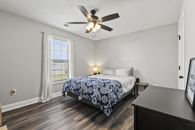 bedroom featuring visible vents, baseboards, ceiling fan, and dark wood-style flooring