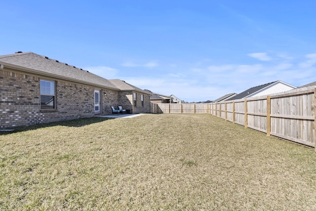 view of yard with a patio and a fenced backyard