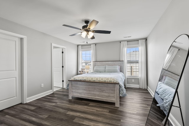 bedroom with visible vents, baseboards, dark wood-style flooring, and ceiling fan