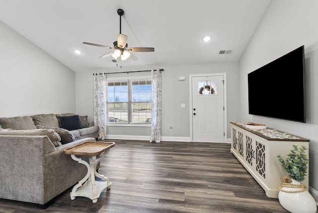 living room featuring visible vents, dark wood-type flooring, baseboards, ceiling fan, and vaulted ceiling