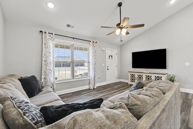 living area with visible vents, baseboards, ceiling fan, vaulted ceiling, and dark wood-style flooring