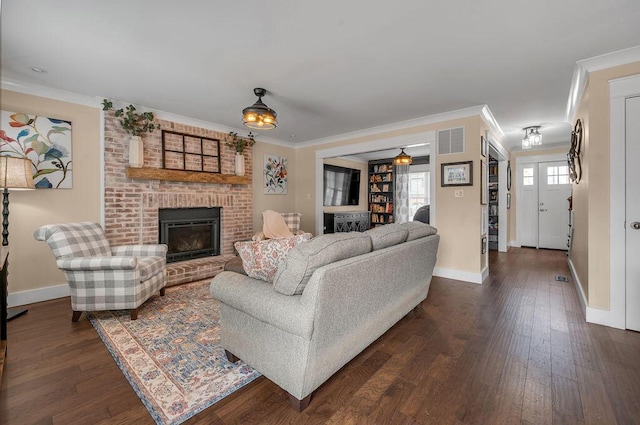 living area featuring visible vents, ornamental molding, dark wood finished floors, a fireplace, and baseboards