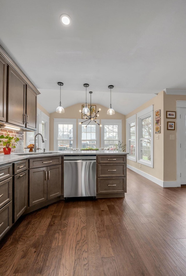 kitchen featuring dark wood finished floors, decorative light fixtures, dishwasher, light countertops, and lofted ceiling