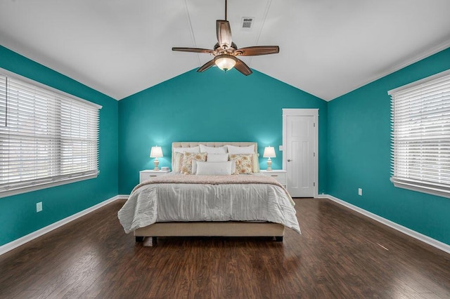 bedroom featuring visible vents, lofted ceiling, baseboards, and wood finished floors