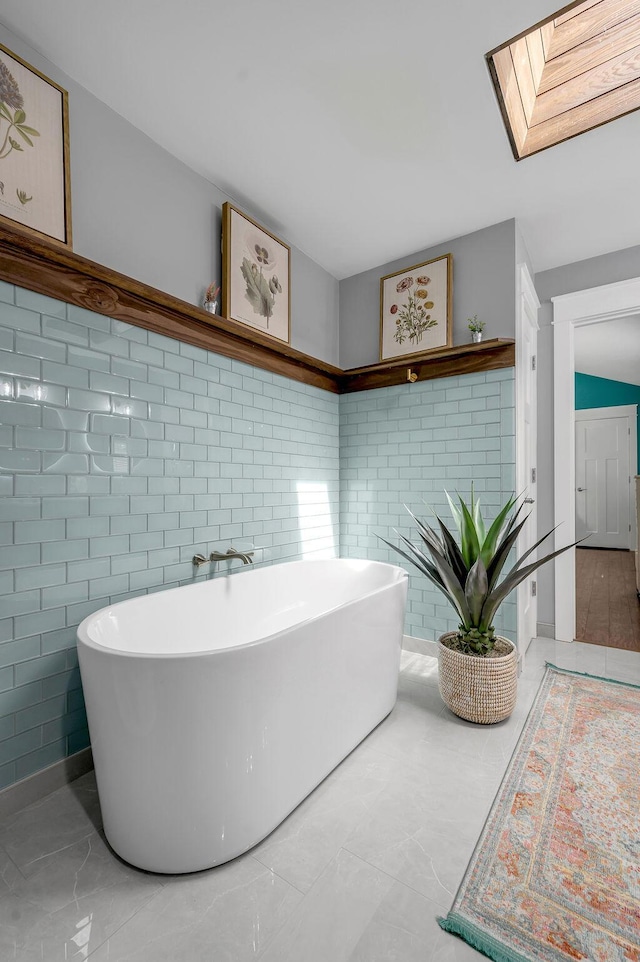 bathroom with a freestanding bath and a skylight