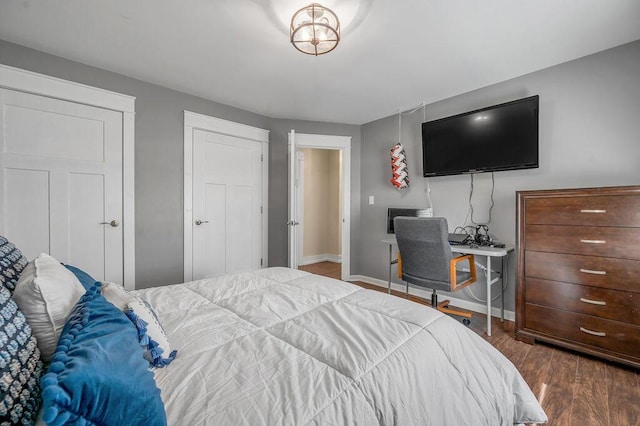 bedroom featuring baseboards and wood finished floors