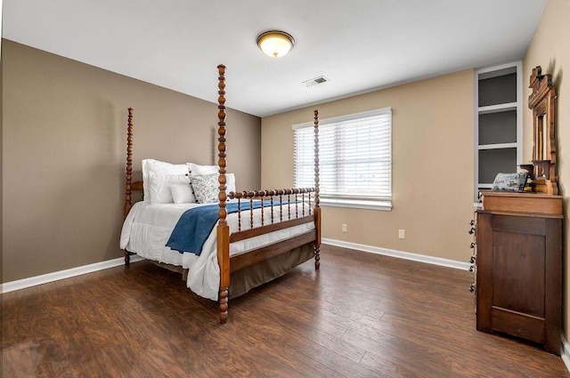 bedroom with visible vents, dark wood-style flooring, and baseboards