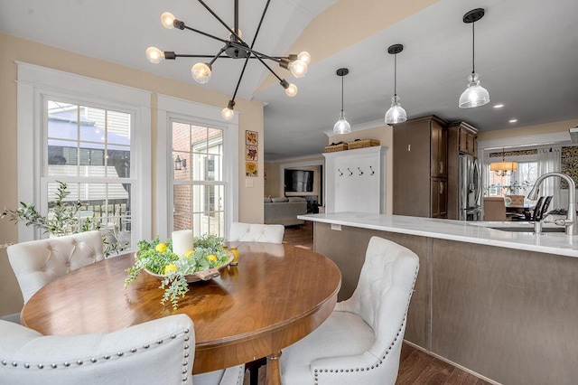 dining area with dark wood finished floors and a chandelier