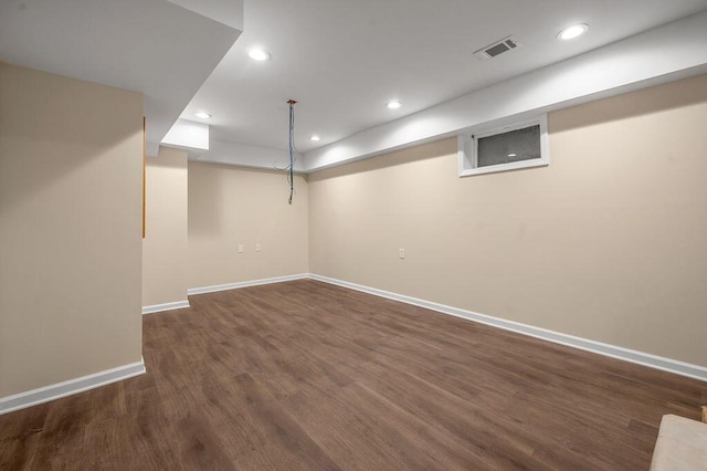 finished basement featuring recessed lighting, dark wood-style floors, visible vents, and baseboards