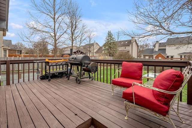 wooden deck with a residential view, area for grilling, and fence