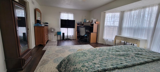 bedroom with visible vents and dark wood-style flooring