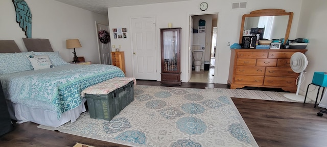 bedroom featuring visible vents and wood finished floors