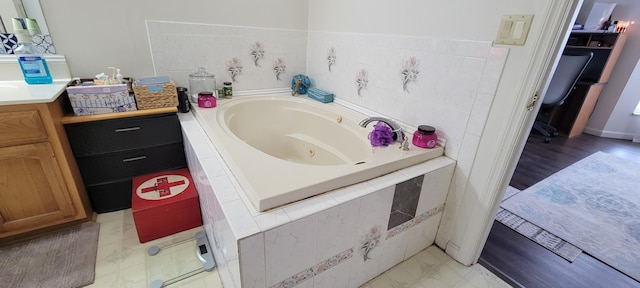 full bathroom featuring vanity and a jetted tub