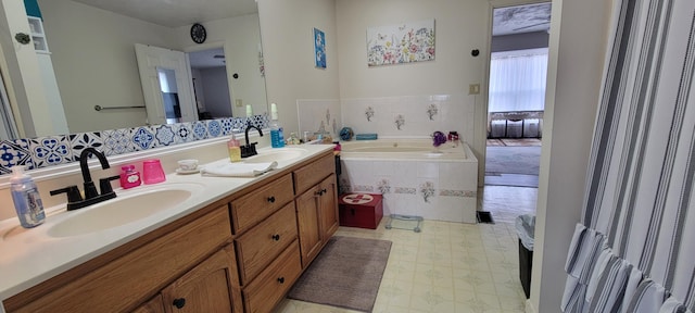 full bathroom with a bath, tile patterned floors, double vanity, and a sink