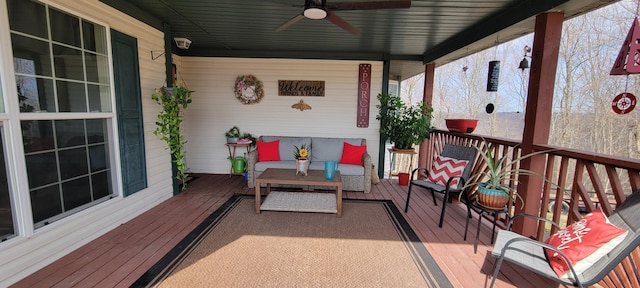 wooden deck featuring an outdoor hangout area and a ceiling fan