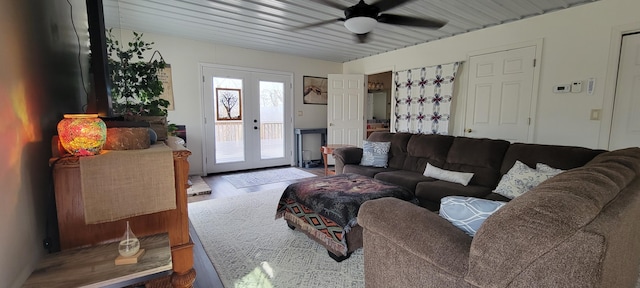 living area with french doors, ceiling fan, and wood finished floors