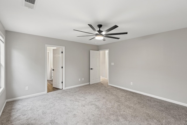 unfurnished bedroom featuring visible vents, baseboards, a ceiling fan, and carpet flooring