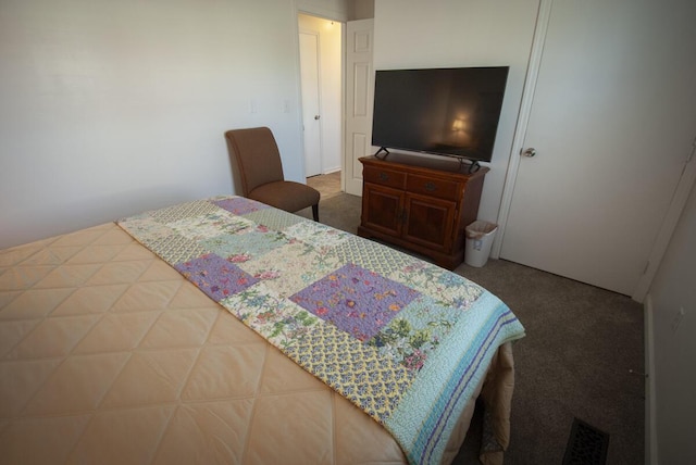 carpeted bedroom featuring visible vents