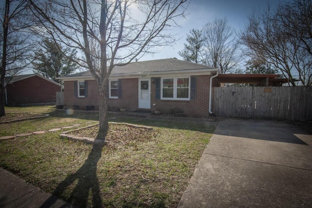 view of front of house featuring fence, a front yard, crawl space, an attached carport, and brick siding