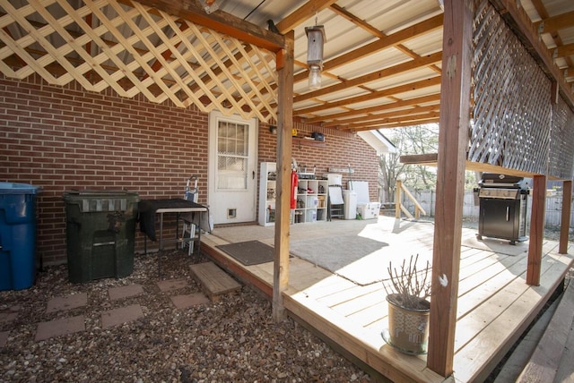 wooden deck featuring a patio and grilling area