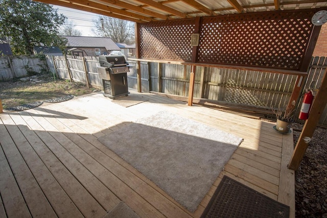 wooden deck with a grill and fence