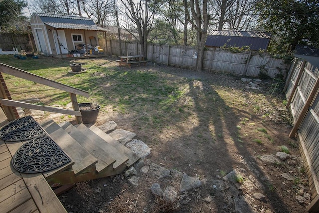 view of yard featuring an outdoor structure and a fenced backyard