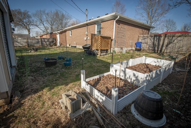 view of yard with a vegetable garden and fence