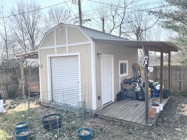 view of outbuilding featuring an outbuilding and fence