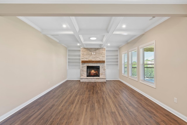 unfurnished living room with baseboards, coffered ceiling, beam ceiling, a fireplace, and dark wood-type flooring