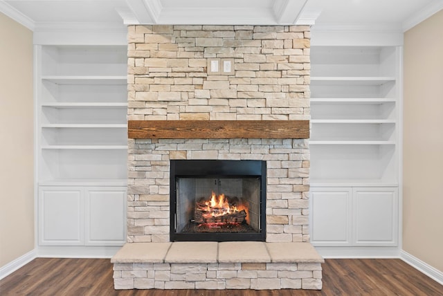 room details featuring a fireplace, crown molding, baseboards, and built in shelves