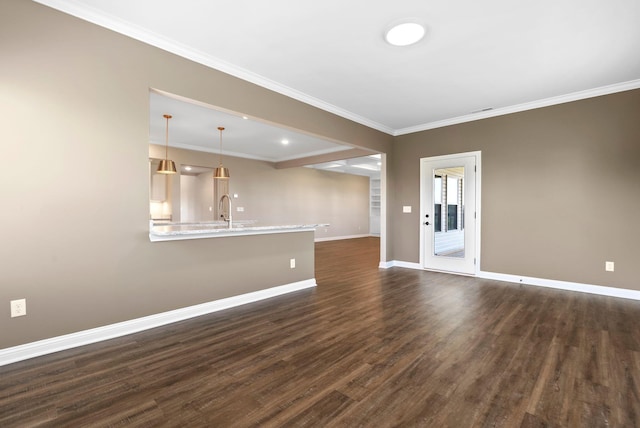 empty room with crown molding, baseboards, and dark wood-style flooring