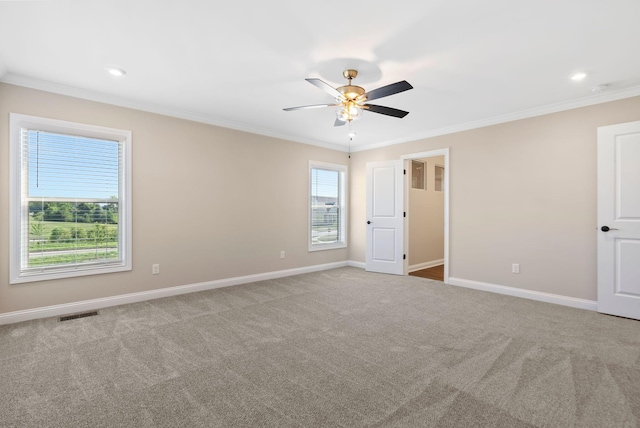 unfurnished bedroom featuring visible vents, ornamental molding, a ceiling fan, carpet floors, and baseboards