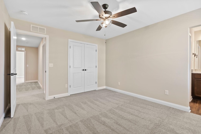 unfurnished bedroom featuring a closet, visible vents, carpet flooring, and baseboards