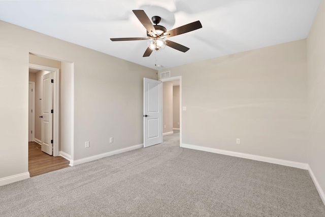 unfurnished bedroom with carpet flooring, visible vents, and baseboards