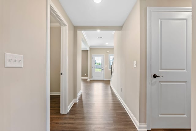 corridor with baseboards, dark wood finished floors, and crown molding