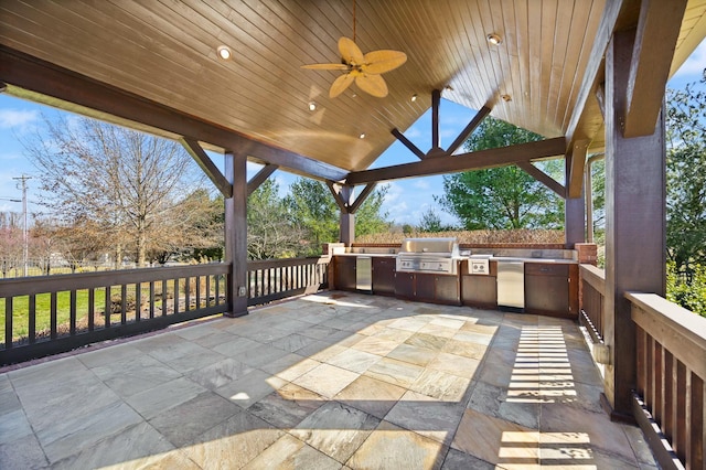 view of patio with grilling area, exterior kitchen, and a ceiling fan